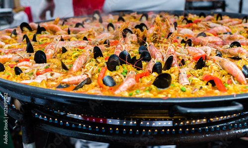Seafood paella in a paella pan at a street food market