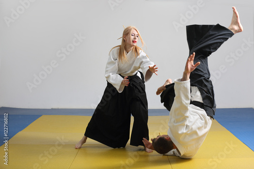 martial art of Aikido. girl and man demonstrate techniques of