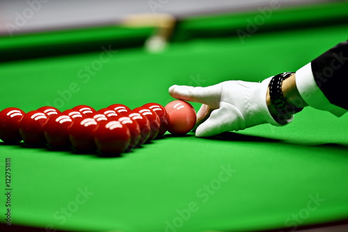 Snooker referee arranging pink ball