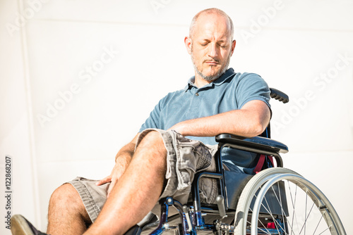 Disabled man with handicap on wheelchair in depression moment - Disability concept with powerless unhelped person sitting alone on wheel chair - Social issues with invalid guy on difficulties 