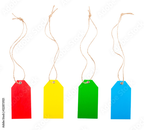Colored price tags with rope on white, isolated background. Top view. Flat lay.