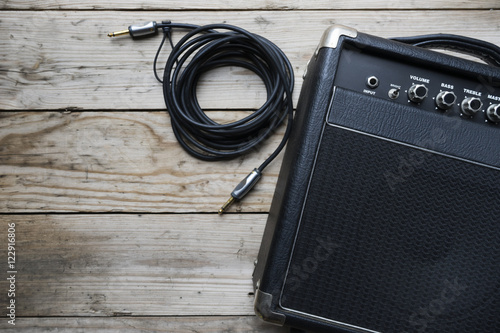 Guitar amplifier and guitar on wood table