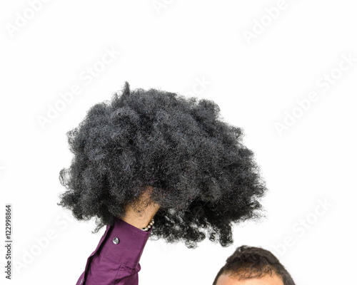 man holding a wig in hand