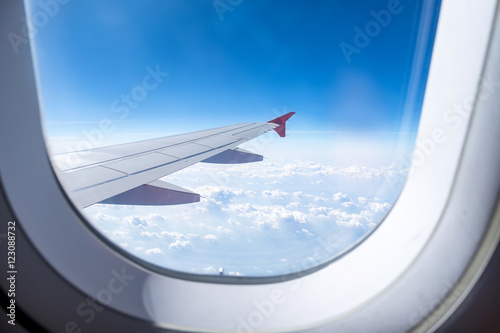 Close up Airplane window with airplane wing ,Traveling concept