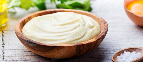 Homemade mayonnaise, mayo in a wooden bowl. White background.