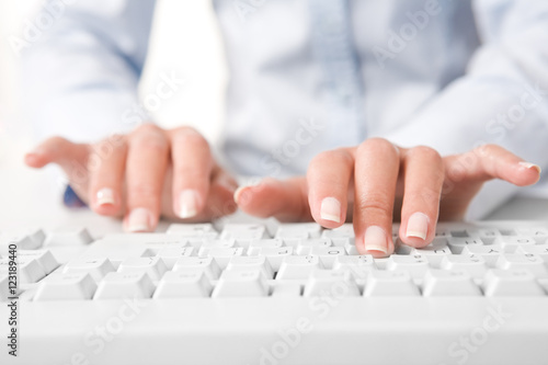 Photo of human fingers pushing the buttons of keyboard
