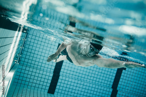 Professional male swimmer inside swimming pool