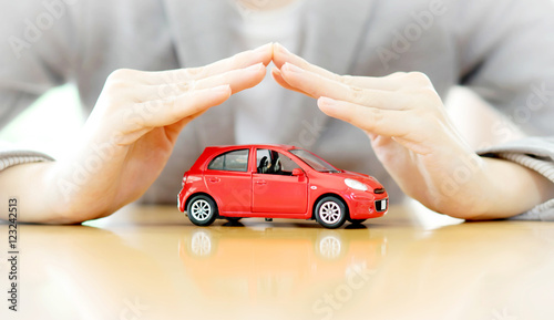 Businesswoman hands and car as protection of car concept