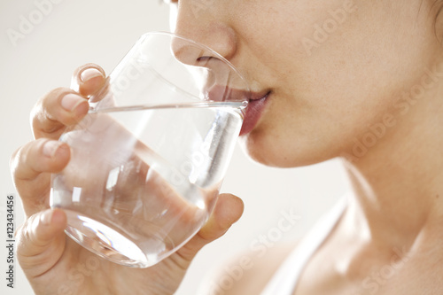 Young woman drinking glass of water