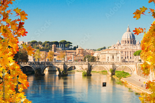 St. Peter's cathedral over bridge and river water at fall day in Rome, Italy