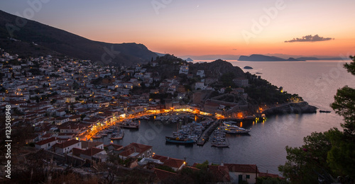 Top view twilight of Hydra island, Greece - city center and yaht marina after sunset.