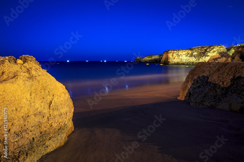 Lagos Beach with cliffs and fishermen's boat, Portugal