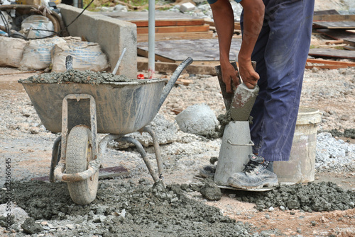 Construction workers doing slump test using equipment at the construction site. 