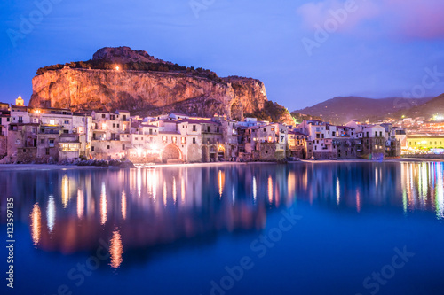 View on habour and old houses in Cefalu at night, Sicily. Beautiful townscape of old italian town. Travel photography.