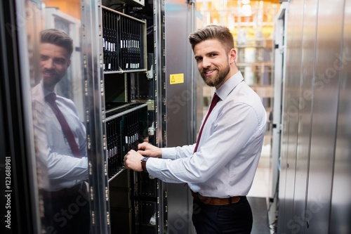 Technician examining server