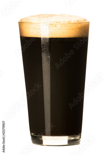 PInt of dark stout beer with thick foam head isolated on white background