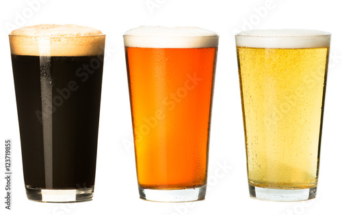 Three foamy pints stout ale pilsner lager beer isolated on white background for use alone or as a design element