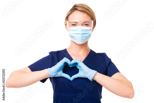 Female Doctor Nurse dental hygienist making heart shape over her heart isolated on white background for use alone or as a design element