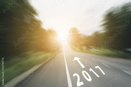 arrow line and 2017 on speed road with sunlight
