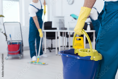 Man holding mop bucket