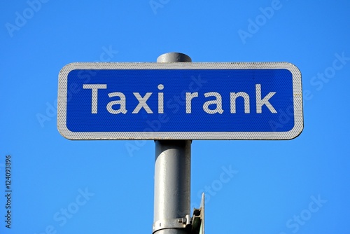 Taxi rank sign against a blue sky.