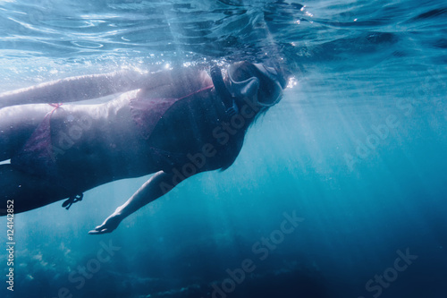 Woman swimming underwater surface