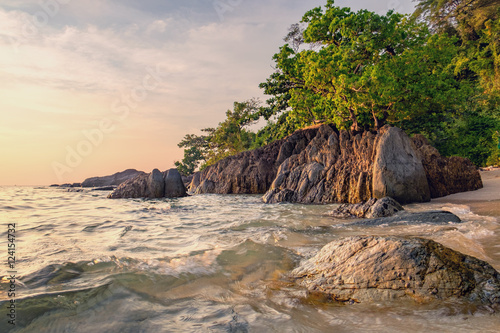 Beautiful seascape. Sea and rock at the sunset. Nature composition. Thai beach in sunset time in Koh Chang island, Thailand.