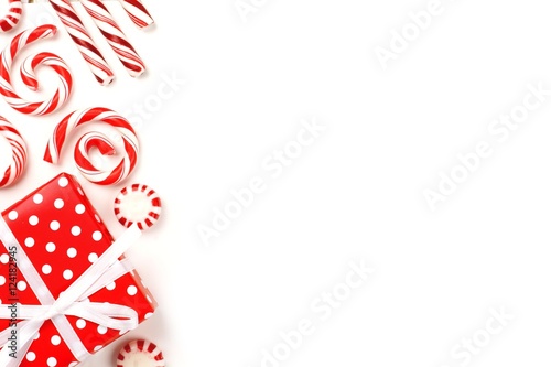 Christmas side border of red and white gifts and peppermint candies over a white background