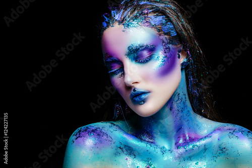 Portrait of a beautiful mermaid girl. Wet skin, wet hair, glitter and scales on his face. Blue eyes. The image on Halloween. Advertising Space.