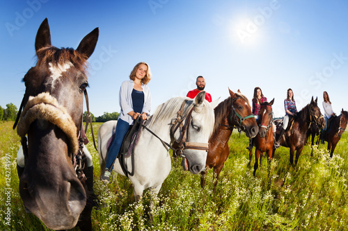 Group of equestrians riding their horses in field