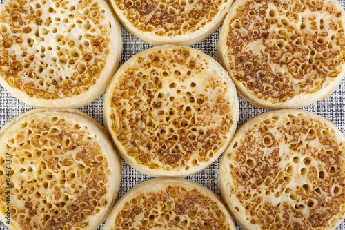 Close up of fresh crumpets on a woven table mat