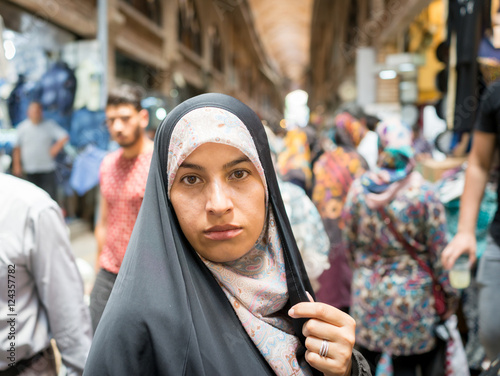 Beautiful Muslim woman spending time on traditional Iranian baza