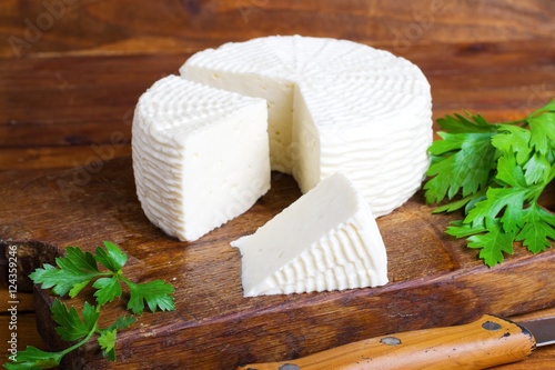 Soft salty cheese on a wooden table