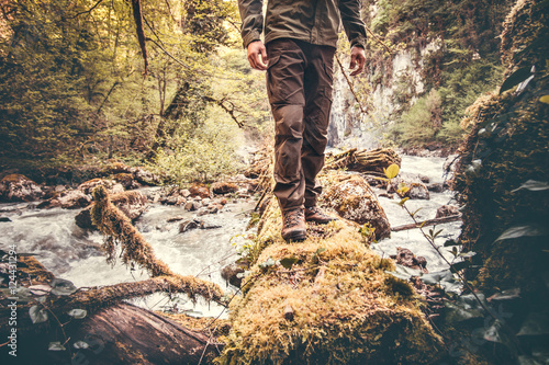 Feet Man hiking outdoor with river and forest on background Lifestyle Travel survival concept