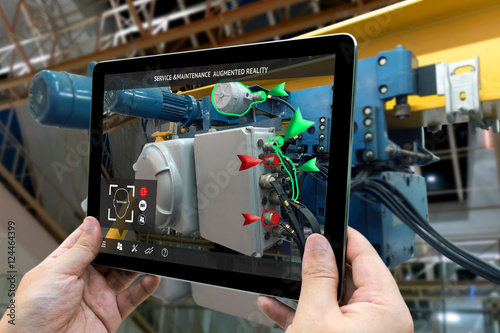 Industrial 4.0 , Augmented reality concept. Hand holding tablet with AR service , maintenance application and calling technician for check destroy part of smart machine in smart factory background