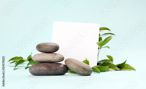 Blank paper surrounded by balanced spa stones