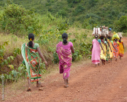 Tribal women carry goods on their heads in Ankadeli, Orissa in India