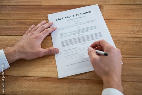 Businessman filling last will and testament form