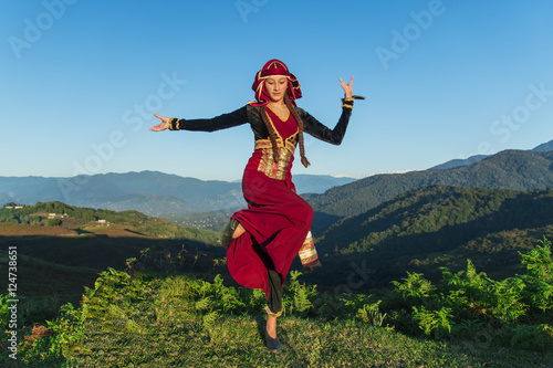 young woman dancing georgian national clothes mountains outdoors summer sunny