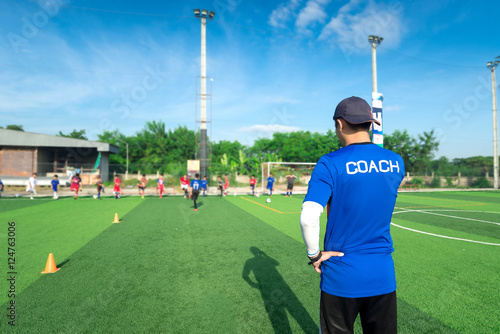 blurred image of Coach is coaching Children Training In Soccer T