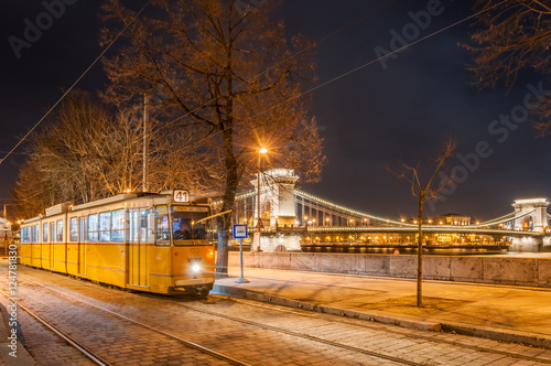 Night view of the tram on the background of the Chain Bridge in Budapest, Hungary.