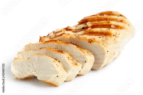  Partially sliced grilled chicken breast with black pepper and rock salt.