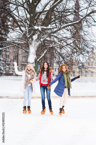Young and happy women skating outdoors in the winter