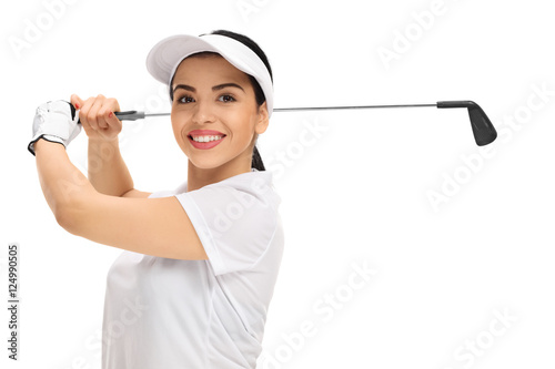 Cheerful female golf player swinging a golf bat