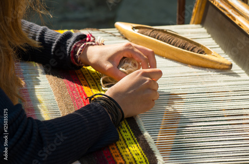 Crafts. Hand weaving loom with many colorful woolen threads.