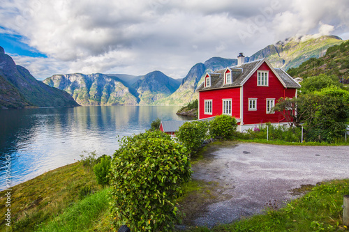 View to Sognefjord in Norway. Small town and cruise port Olden in Norwegian fjords. Bird view of fjord in Norway. under a sunny, blue sky, with the typical rorbu houses. View from the top