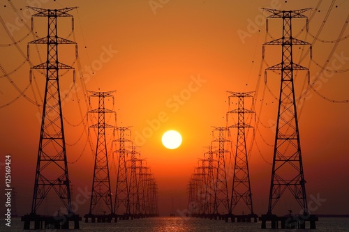 pylon - steel tower, sun come up in the middle of the pylon