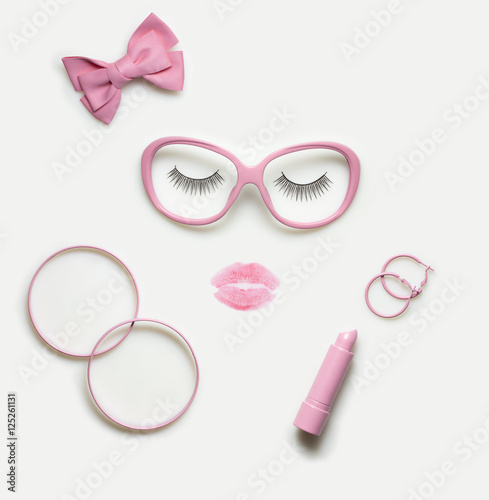Creative concept photo of accessory and makeup set as a portrait of a woman on white background / Sleeping beauty.