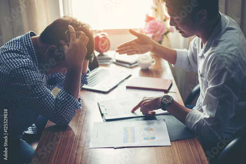 Serious boss complain to employees about work mistake at office.