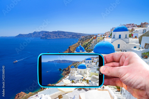 Making photos by smartphone of Santorini island